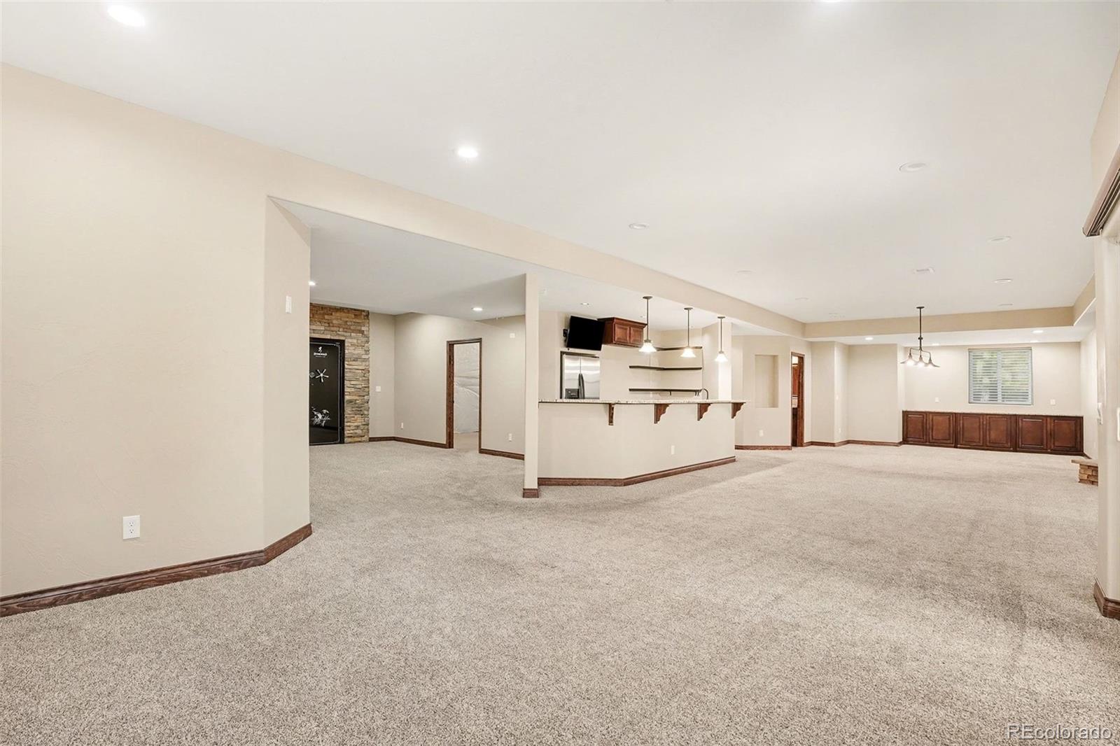 7936 Monarch Road Larkspur, CO 80118 - Photo 20 of 24 a view of a livingroom with a kitchen and a refrigerator
