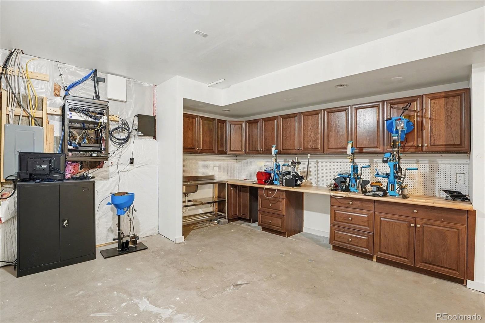 7936 Monarch Road Larkspur, CO 80118 - Photo 22 of 24 a kitchen with cabinets and wooden floor