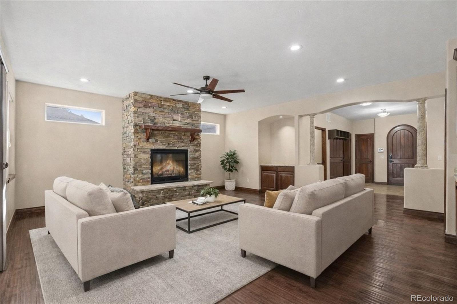 7936 Monarch Road Larkspur, CO 80118 - Photo 4 of 24 a living room with furniture and a fireplace