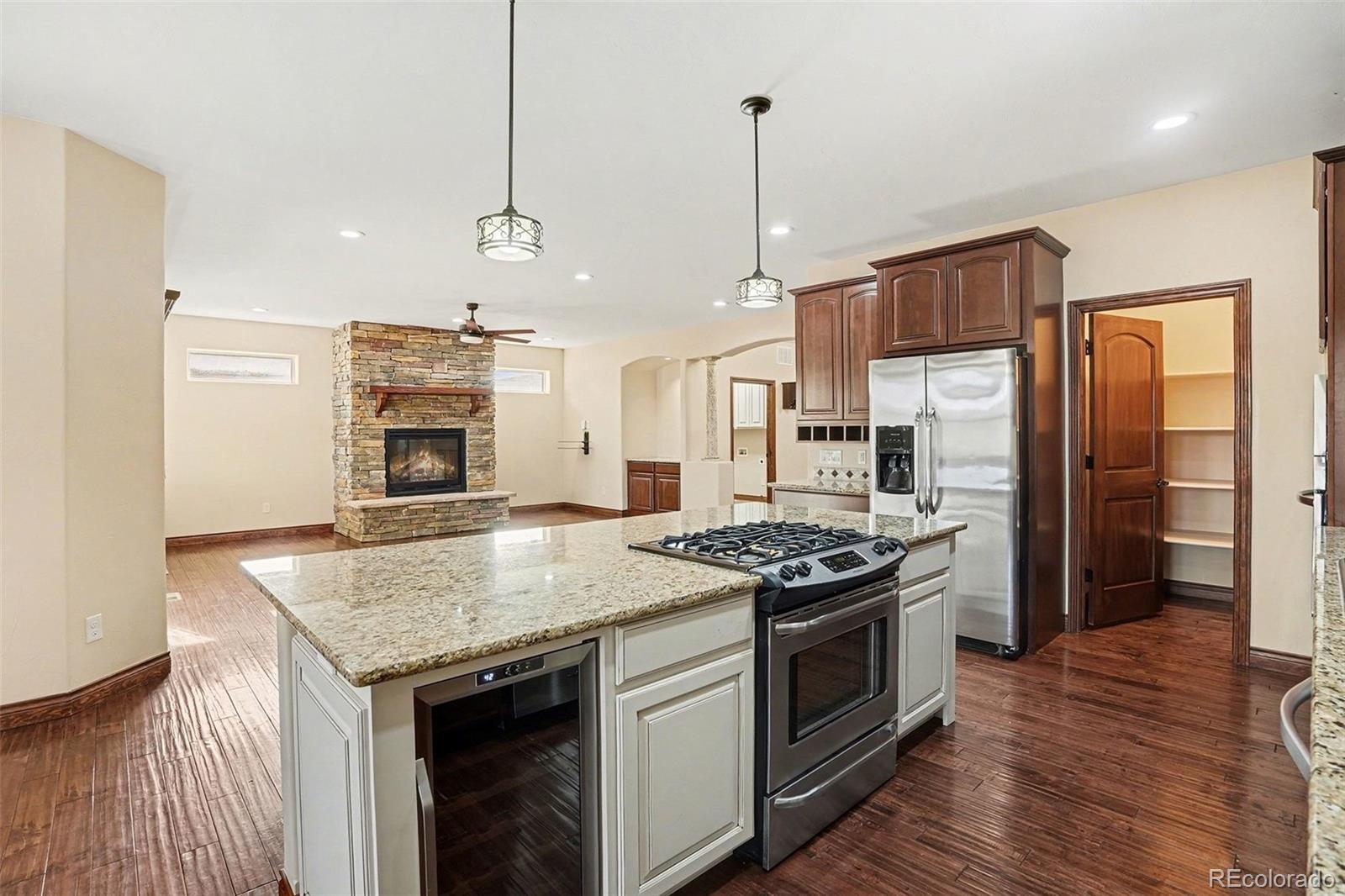 7936 Monarch Road Larkspur, CO 80118 - Photo 5 of 24 a kitchen with stainless steel appliances granite countertop a stove a refrigerator and a sink