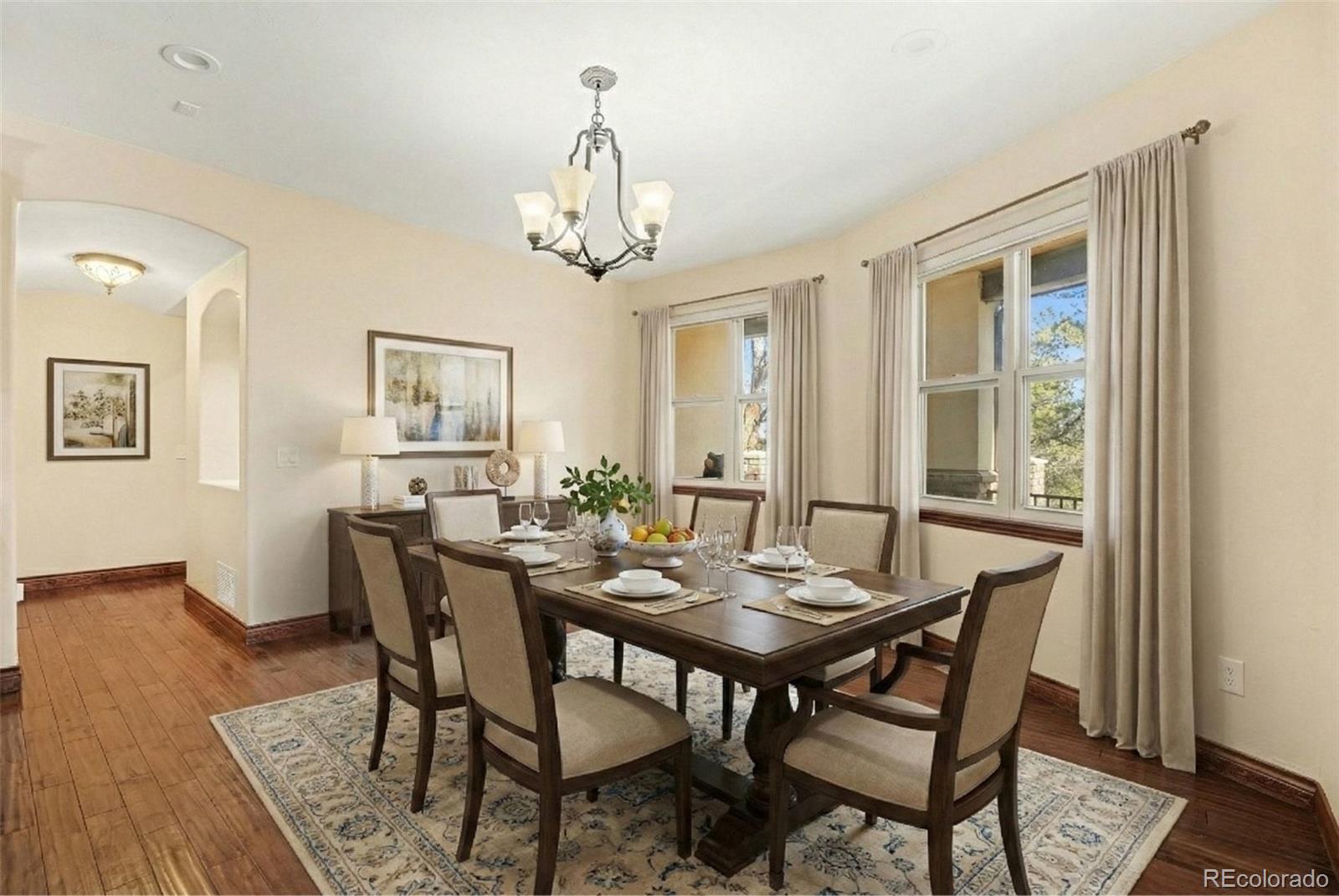 7936 Monarch Road Larkspur, CO 80118 - Photo 8 of 24 a view of a dining room with furniture window and wooden floor
