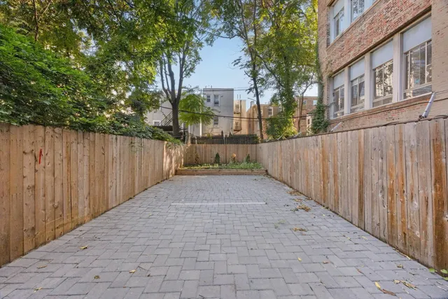 a view of a pathway with a wrought fence