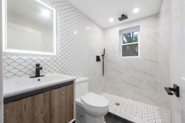 a bathroom with a sink toilet and shower
