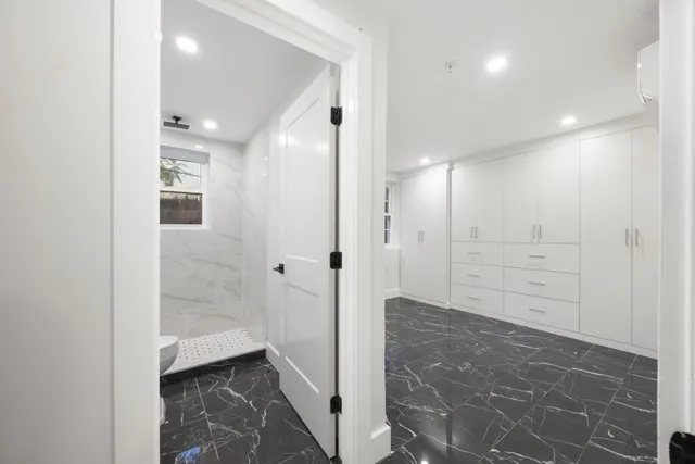 a bathroom with a glass door shower