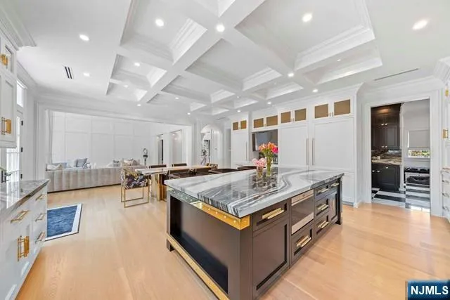 a living room with stainless steel appliances furniture stove and kitchen view