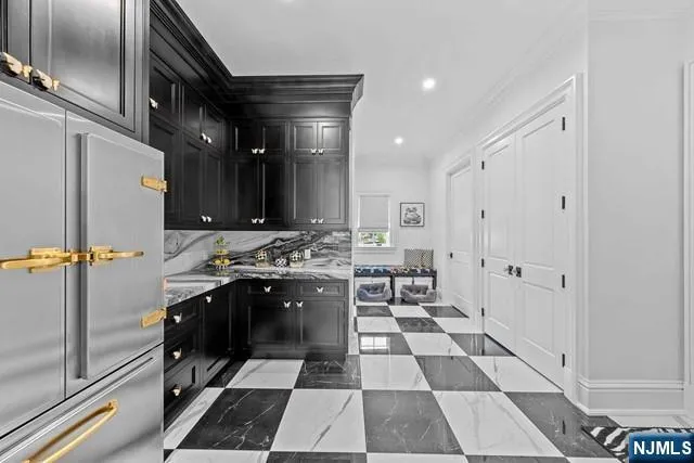 a large kitchen with a sink and stainless steel appliances