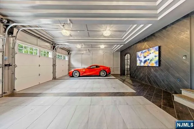 a bedroom with a bed a flat screen tv and bookshelf