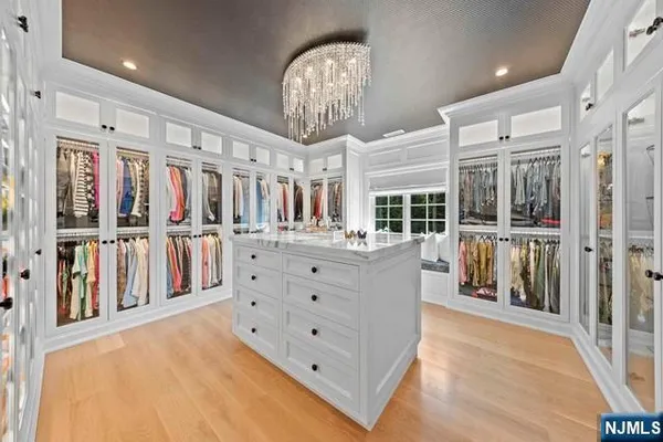 a spacious bathroom with a sink a bathtub and a chandelier