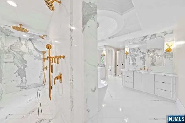 a white bath tub sitting in a bathroom next to a window