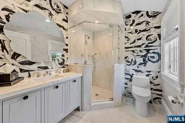 a bedroom with a large bed and a fireplace