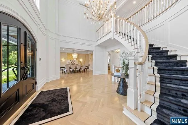 a lobby with furniture and a chandelier