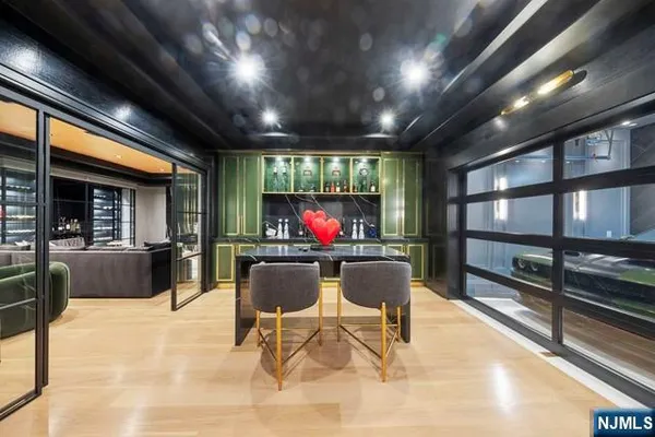 a room with water heater and stainless steel appliances