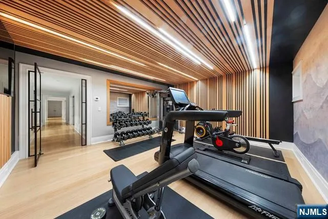 a view of a hallway with furniture and floor to ceiling window