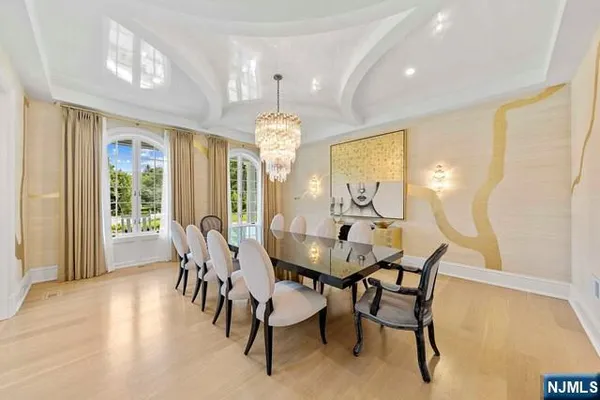 a view of a dining room with furniture and a chandelier