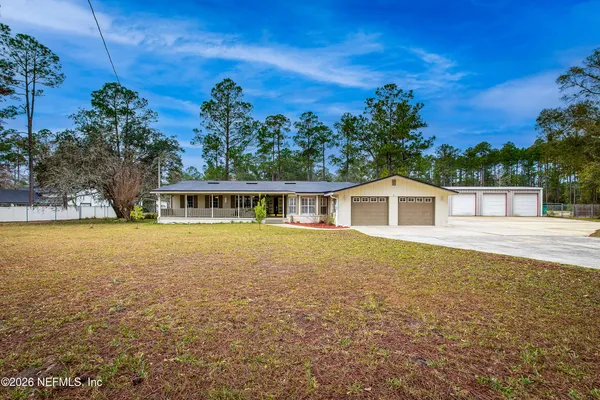 a bathroom with a granite countertop sink a mirror and a shower