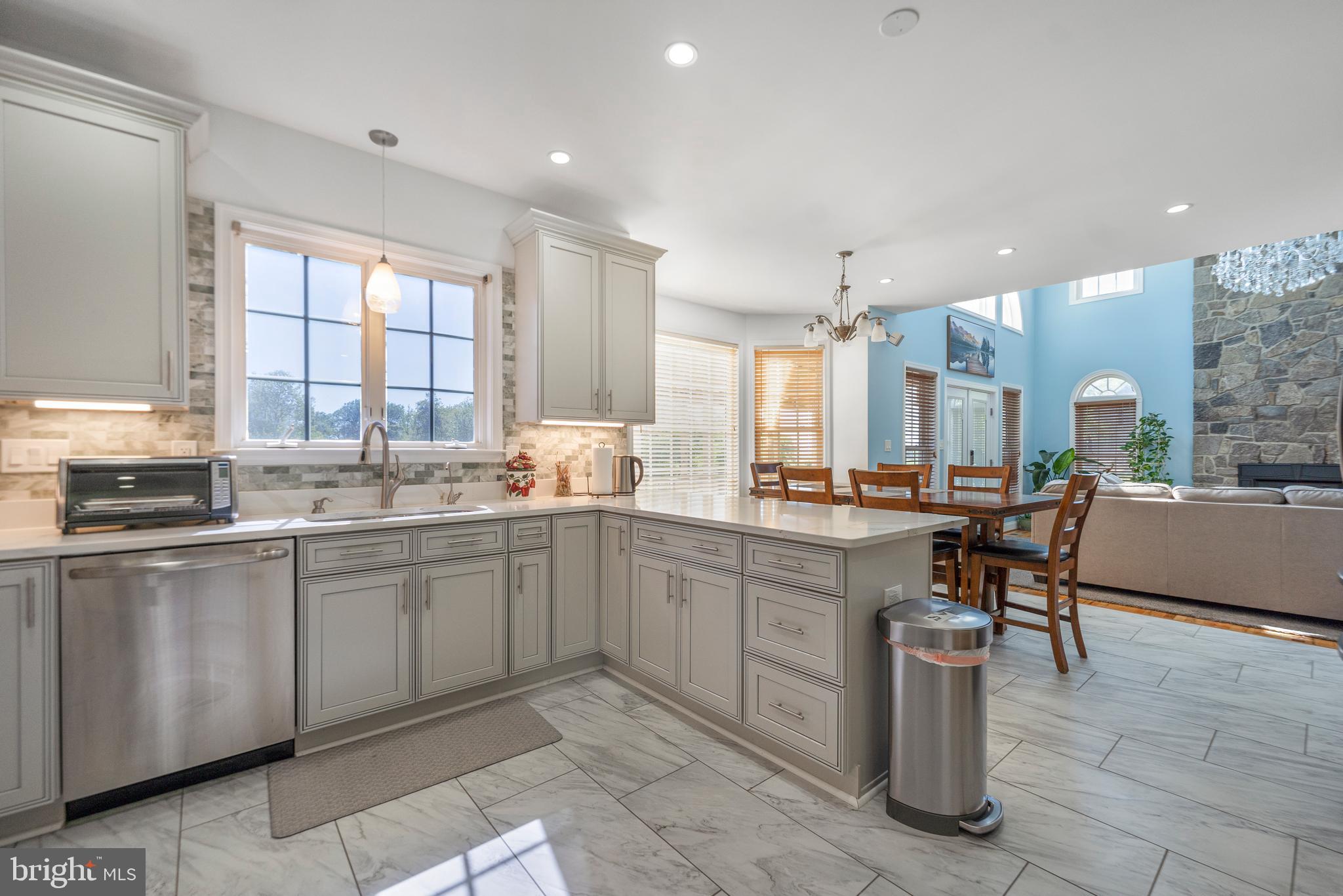 5100 Williams Wharf Road St. Leonard, MD 20685 - Photo 21 of 63 a large kitchen with kitchen island a sink table and chairs