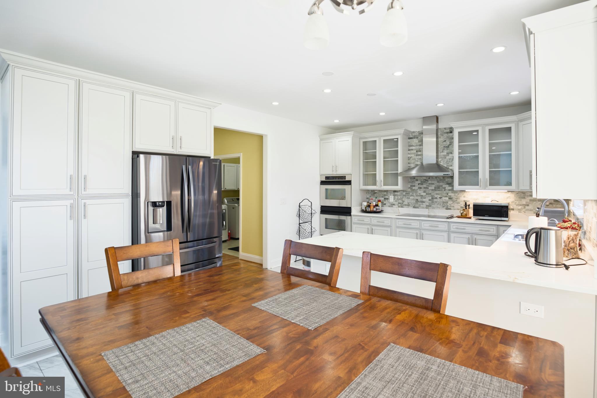 5100 Williams Wharf Road St. Leonard, MD 20685 - Photo 23 of 63 a living room with stainless steel appliances furniture and a table
