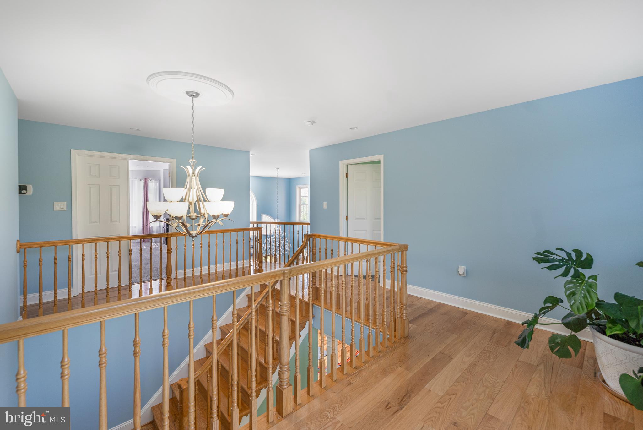 5100 Williams Wharf Road St. Leonard, MD 20685 - Photo 24 of 63 a view of a hallway with wooden floor and windows