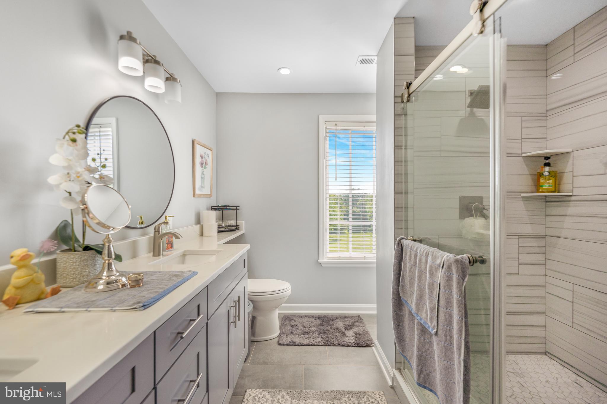5100 Williams Wharf Road St. Leonard, MD 20685 - Photo 32 of 63 a bathroom with a granite countertop sink mirror vanity and a toilet