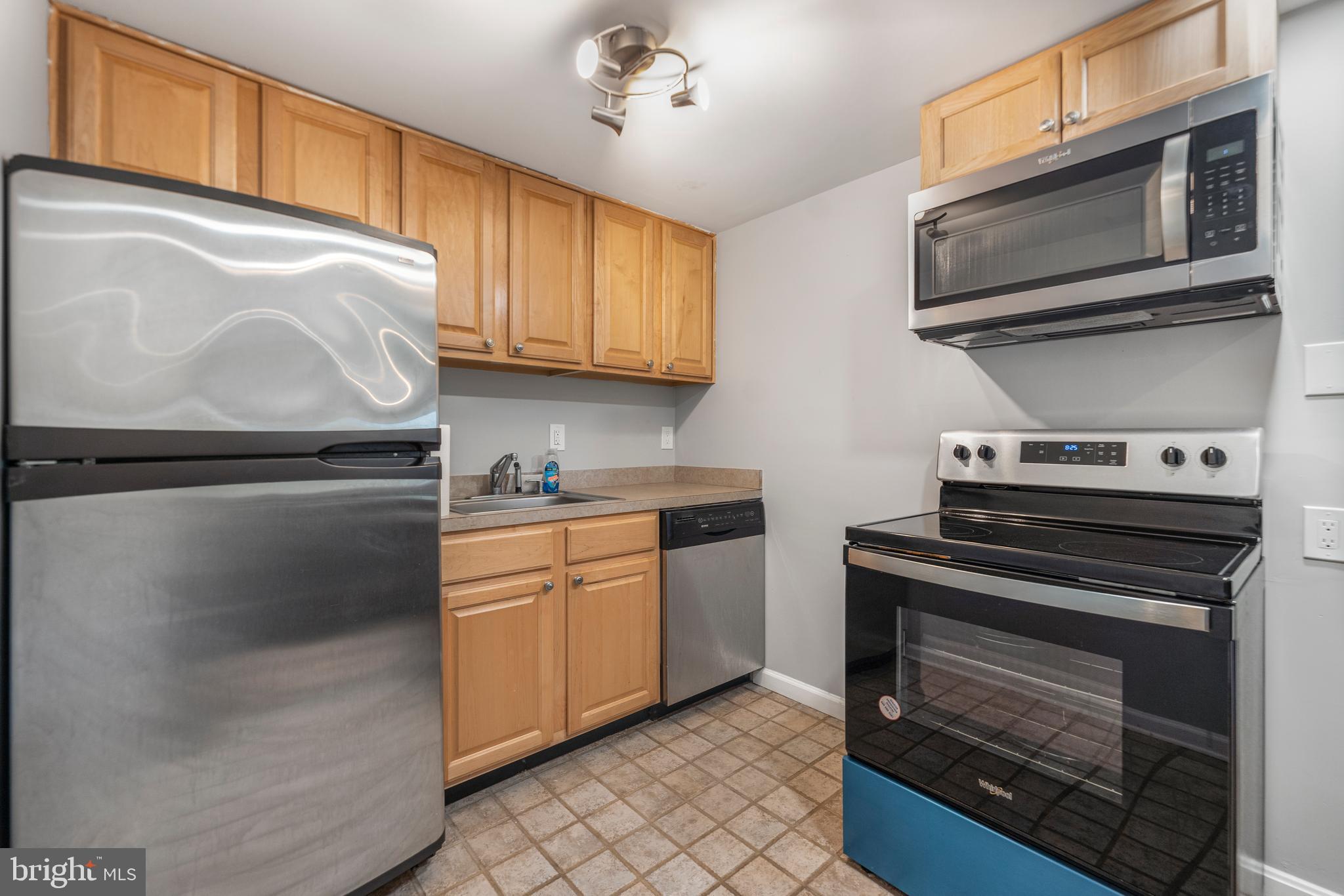 5100 Williams Wharf Road St. Leonard, MD 20685 - Photo 36 of 63 a kitchen with stainless steel appliances granite countertop a stove microwave and refrigerator