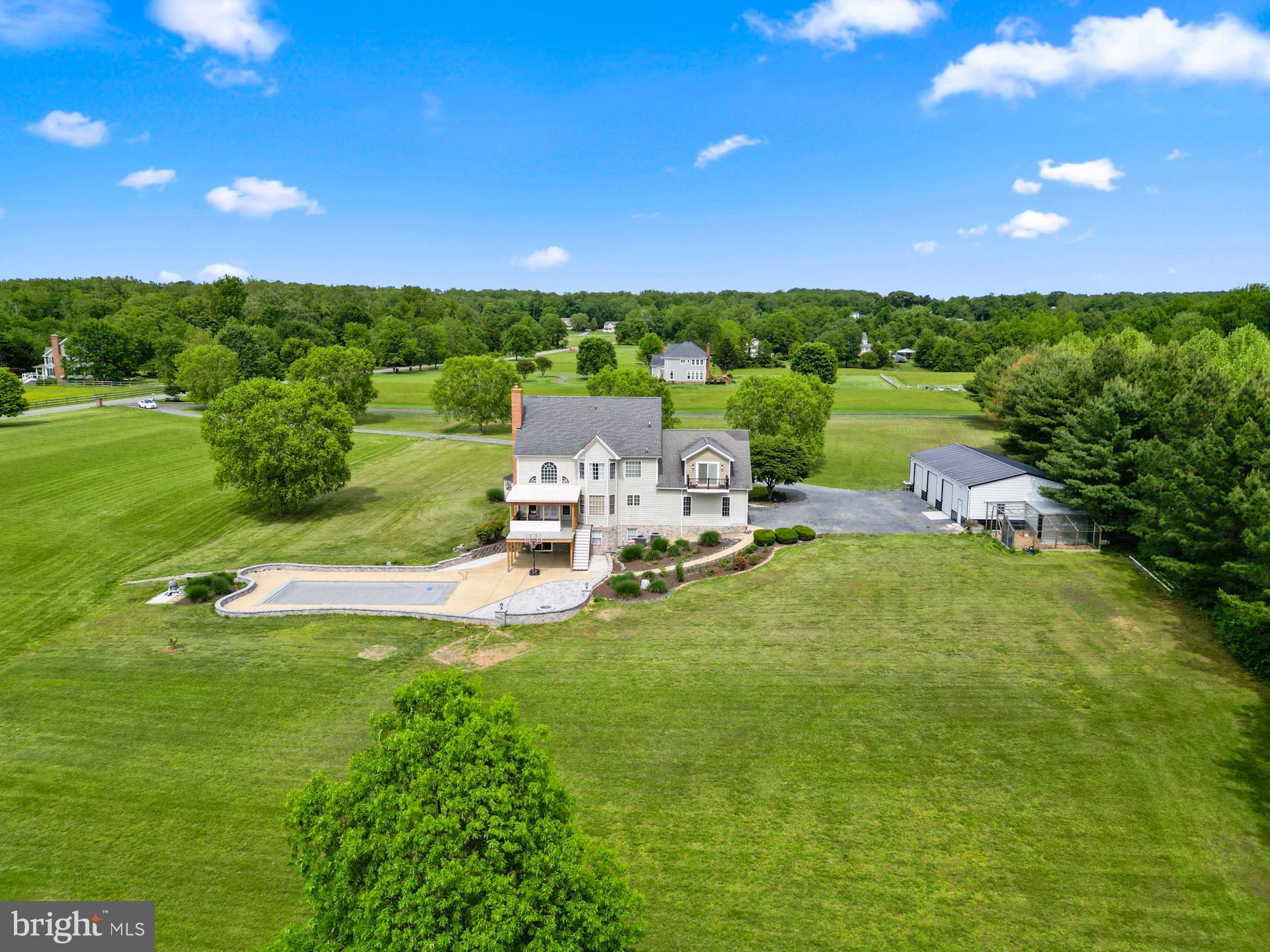 5100 Williams Wharf Road St. Leonard, MD 20685 - Photo 8 of 63 a view of a garden with lawn chairs under an umbrella and yard