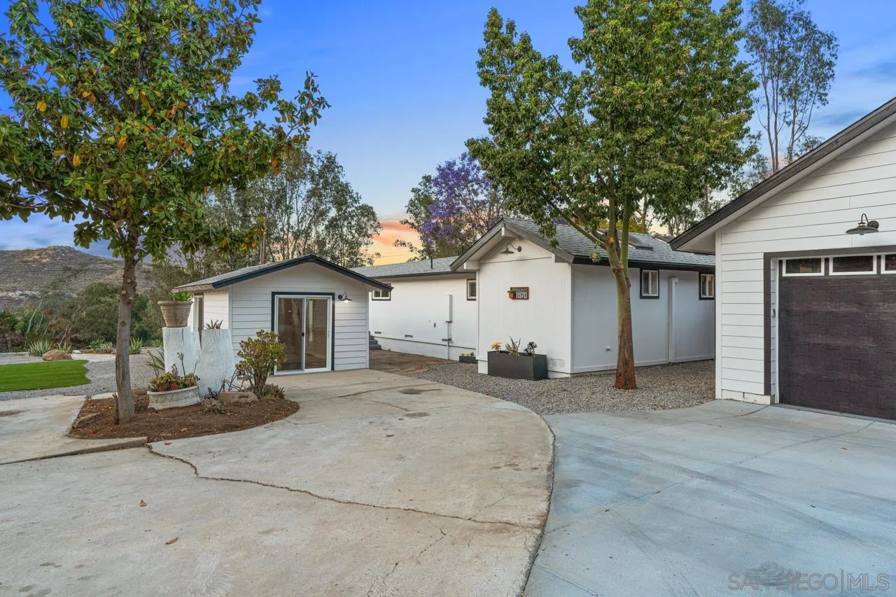 11570 Johnson Lake Road Lakeside, CA 92040 - Photo 25 of 36 a front view of a house with a yard and garage