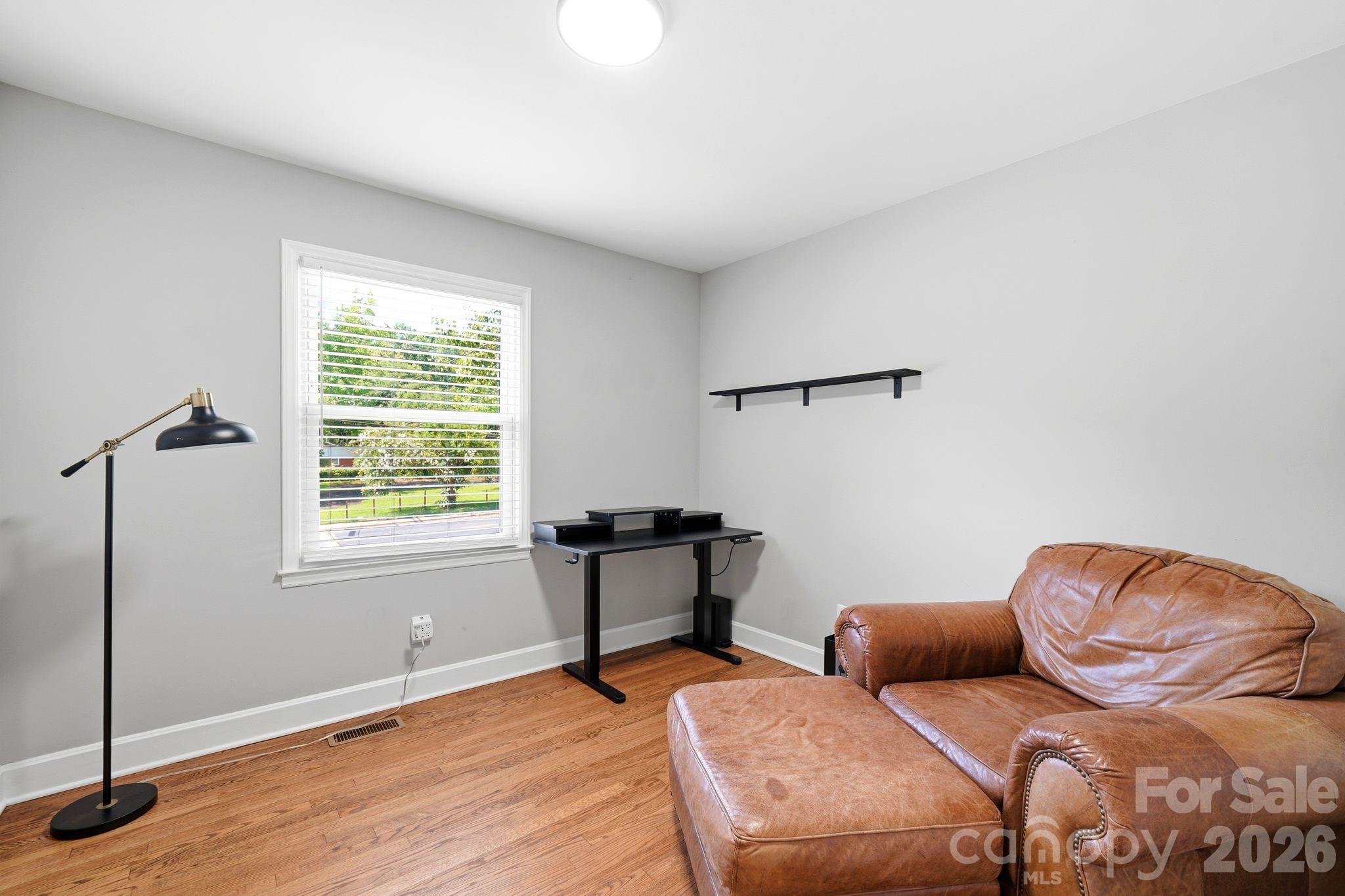 7552 Idlewild Road Charlotte, NC 28212 - Photo 11 of 40 a living room with furniture and a window