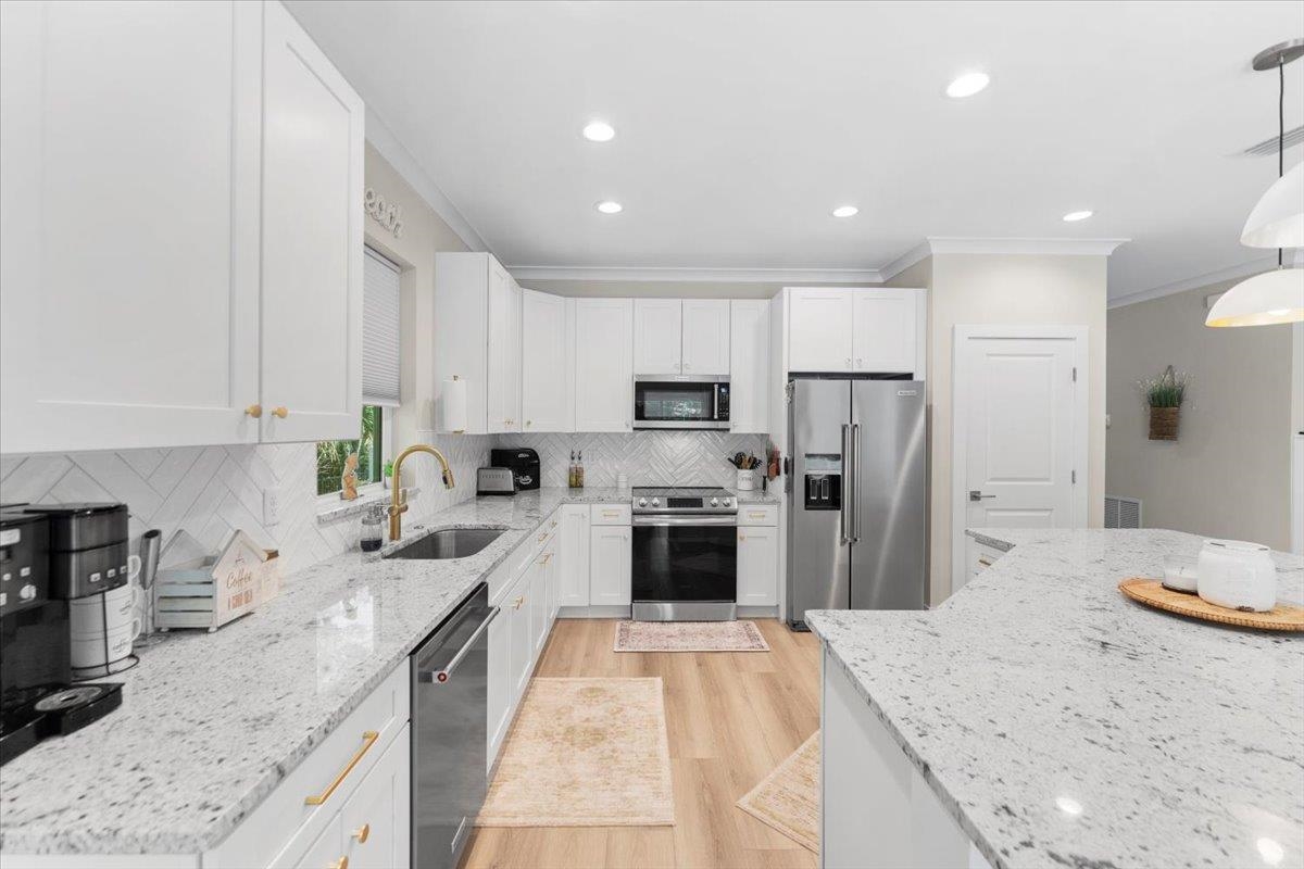 633 West Pope Road St. Augustine, FL 32080 - Photo 14 of 43 a kitchen with refrigerator a sink and a stove