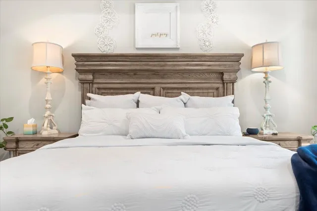 a bedroom with a bed and a mirror