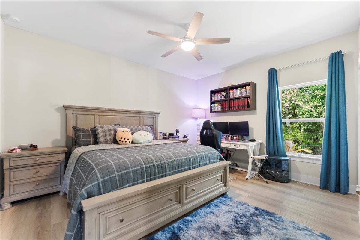 633 West Pope Road St. Augustine, FL 32080 - Photo 22 of 43 a bedroom with a bed a large window with wooden floor