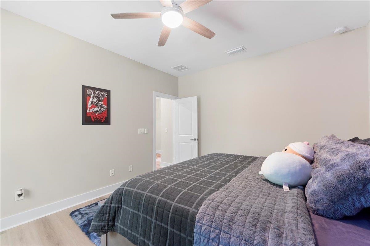 633 West Pope Road St. Augustine, FL 32080 - Photo 23 of 43 a bedroom with a bed and a chandelier fan
