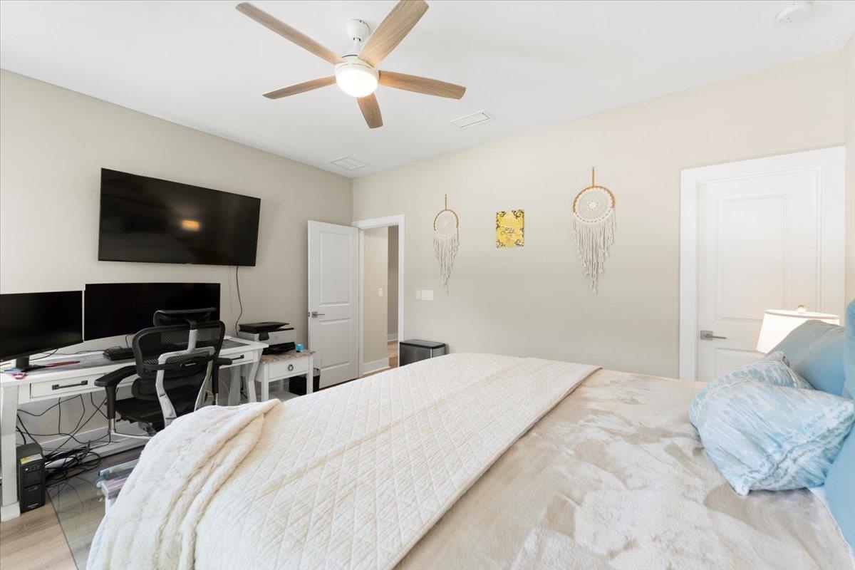 633 West Pope Road St. Augustine, FL 32080 - Photo 26 of 43 a bedroom with a bed and a flat screen tv