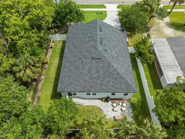 an aerial view of a house with a yard