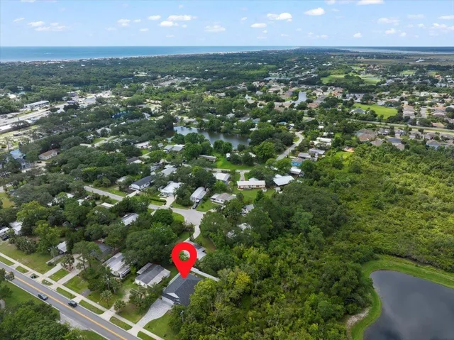 an aerial view of residential houses with outdoor space and swimming pool