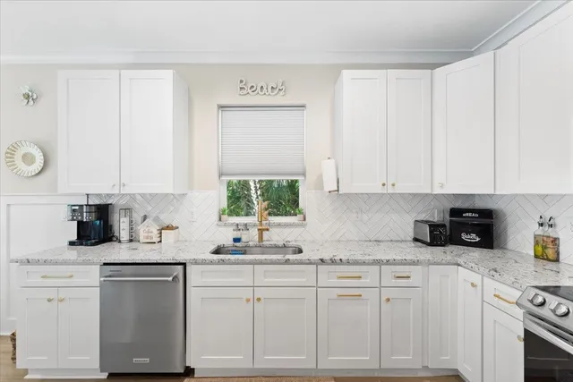 a kitchen with granite countertop white cabinets and white appliances