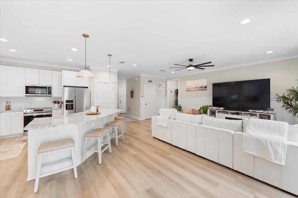 633 West Pope Road St. Augustine, FL 32080 - Photo 9 of 43 a living room with furniture and a flat screen tv