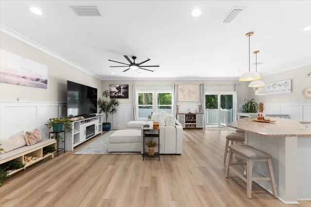 a living room with furniture a flat screen tv and a large window