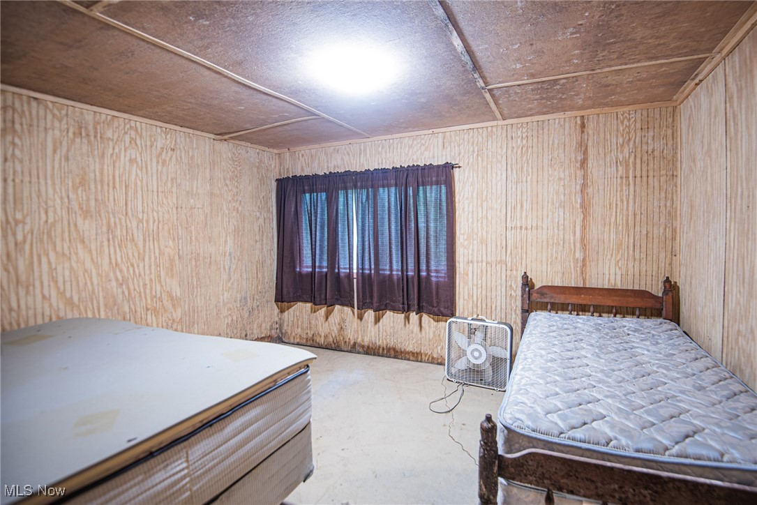 78911 Hamilton Ridge Road Freeport, OH 43973 - Photo 10 of 15 Bedroom with wood walls