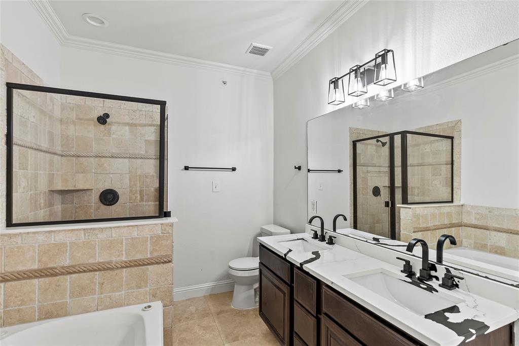 2316 Stutz Drive, Unit A Dallas, TX 75235 - Photo 14 of 24 a bathroom with a sink a toilet and shower