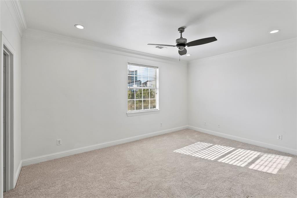 2316 Stutz Drive, Unit A Dallas, TX 75235 - Photo 5 of 24 an empty room with windows and fan