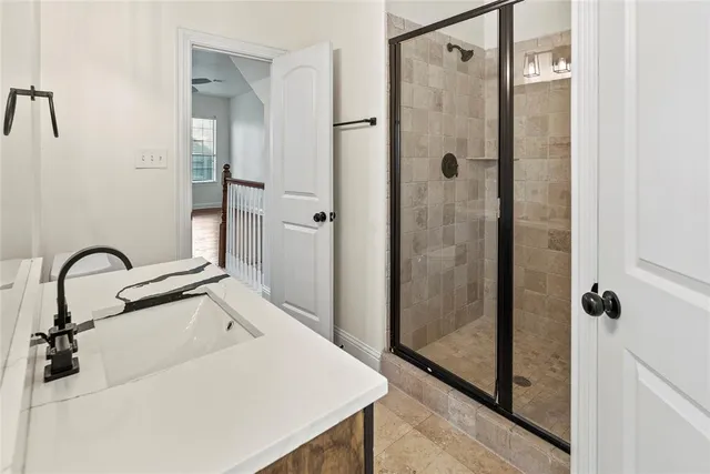 an empty room with a window and a ceiling fan