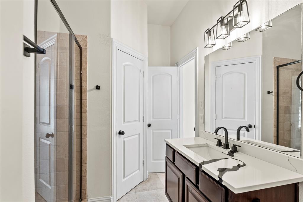 2316 Stutz Drive, Unit A Dallas, TX 75235 - Photo 8 of 24 a bathroom with a sink a mirror and a shower