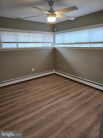 a view of a room with wooden floor