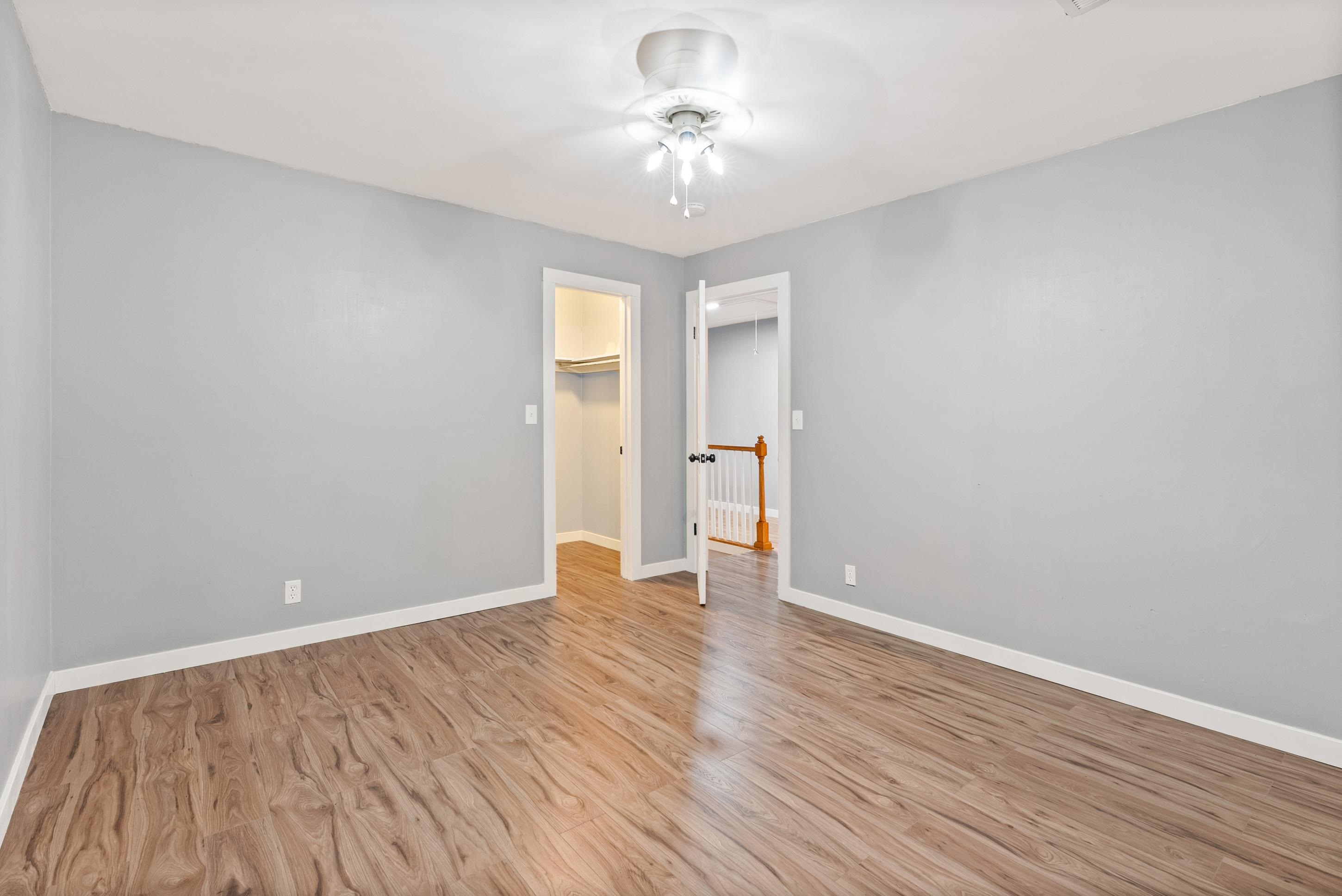 779 Strickland Road Coldwater, MS 38618 - Photo 23 of 40 Wood-finish flooring, light grey wall paint, and a ceiling-mounted light fixture