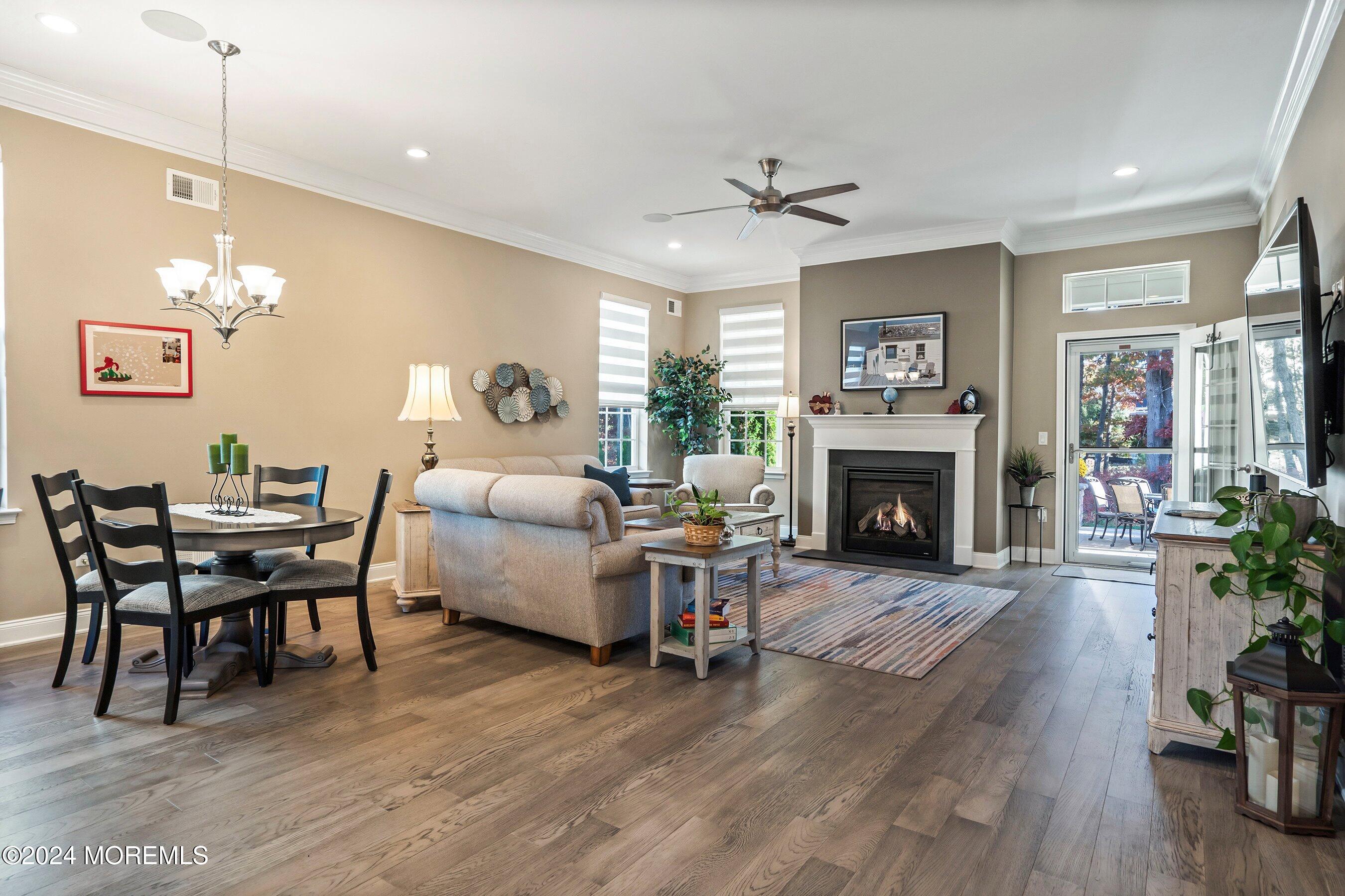 92 Ambermist Way Forked River, NJ 08731 - Photo 12 of 51 a living room with furniture a fireplace and a chandelier