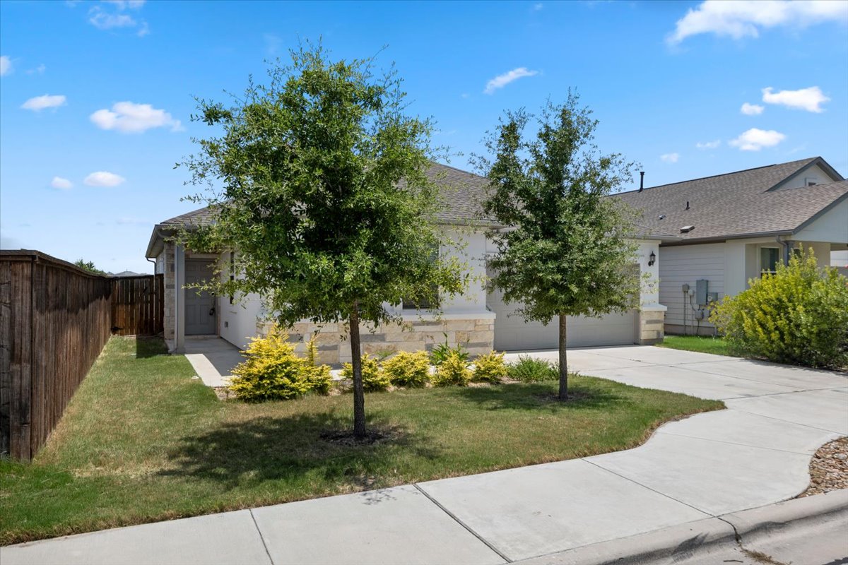 500 Stinchcomb Road Hutto, TX 78634 - Photo 2 of 37 A welcoming facade with a well-maintained lawn and tasteful landscaping.