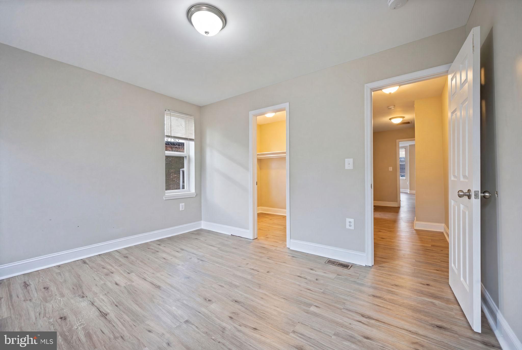 3619 Cottage Avenue Baltimore, MD 21215 - Photo 16 of 31 an empty room with wooden floor and windows