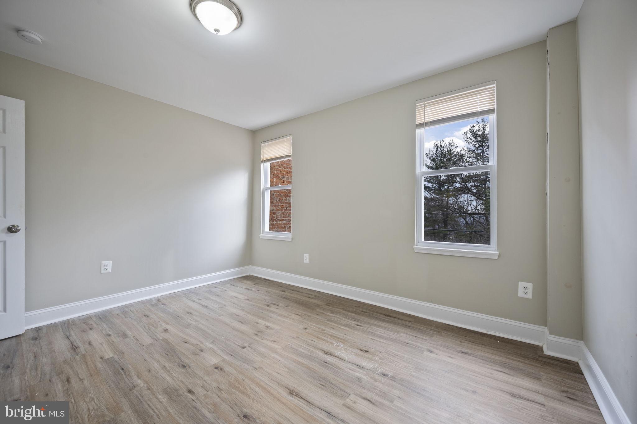 3619 Cottage Avenue Baltimore, MD 21215 - Photo 17 of 31 a view of an empty room with window and wooden floor