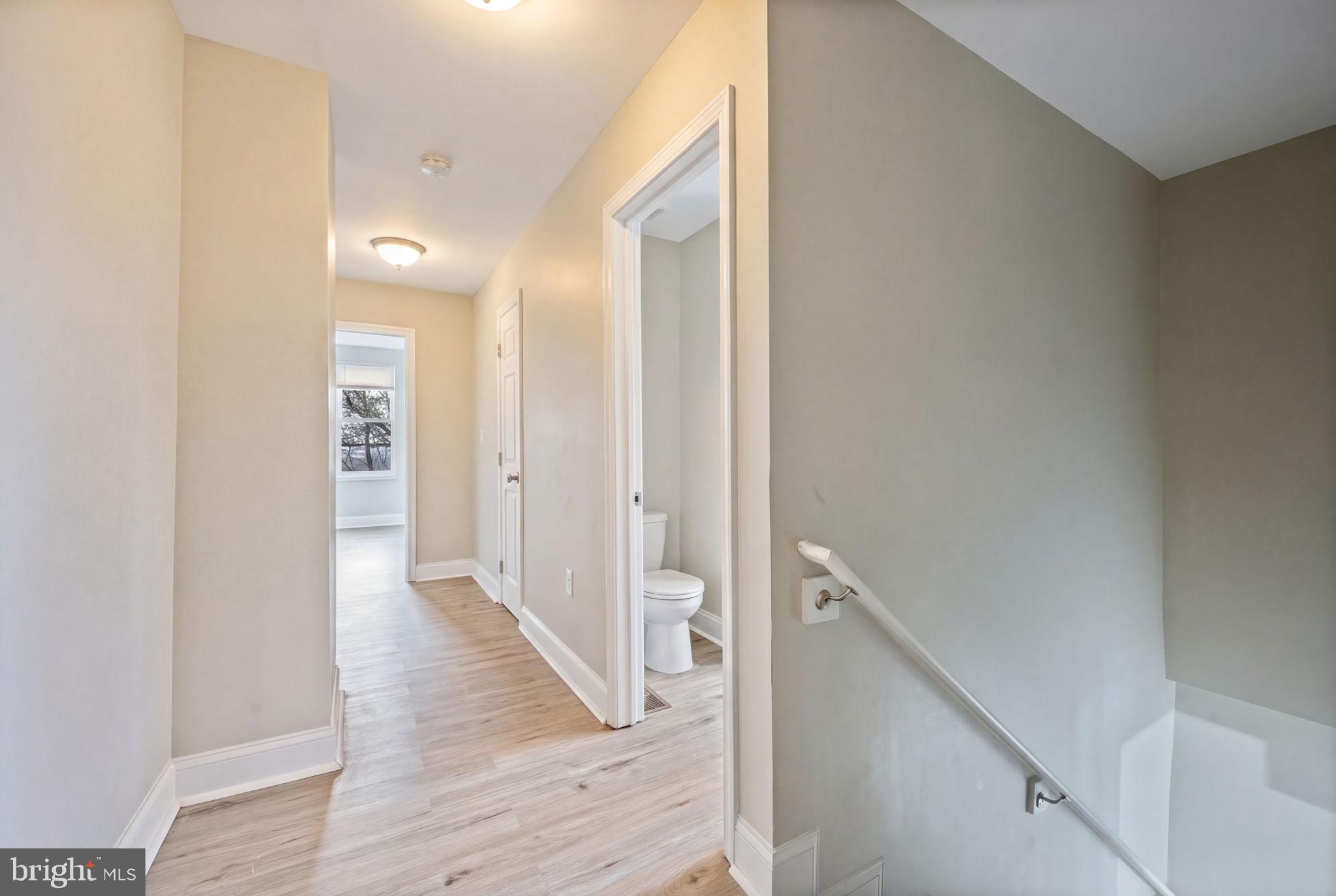 3619 Cottage Avenue Baltimore, MD 21215 - Photo 19 of 31 a view of a hallway with wooden floor and staircase