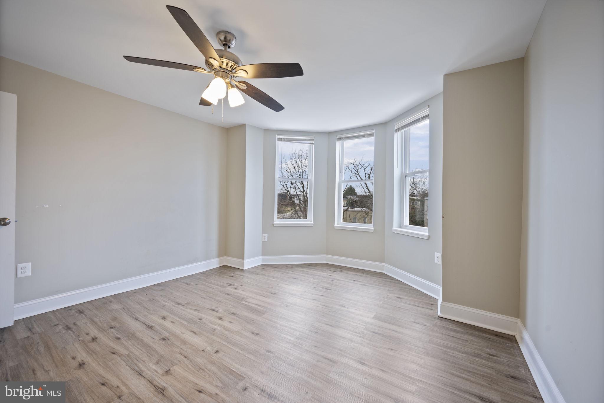 3619 Cottage Avenue Baltimore, MD 21215 - Photo 20 of 31 a view of an empty room with wooden floor and a window